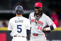 Seattle Mariners' Jonatan Clase (5) talks with Cincinnati Reds shortstop Elly De La Cruz (44) after hitting an RBI double during the fourth inning of a baseball game Tuesday, April 16, 2024, in Seattle. (AP Photo/Lindsey Wasson)