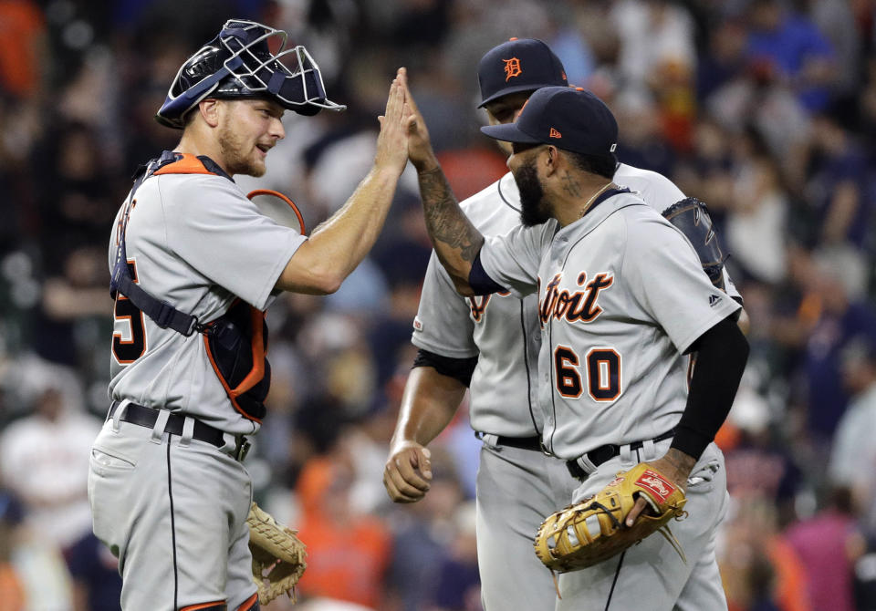 Detroit Tigers' John Hicks, left, celebrates with Ronny Rodriguez (60) and Joe Jimenez after a baseball game against the Houston Astros Wednesday, Aug. 21, 2019, in Houston. The Tigers won 2-1. (AP Photo/David J. Phillip)