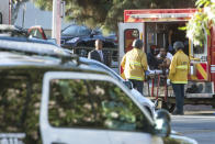 <p>A man is arrested after evading police, holding employees hostage and killing one woman inside of a Treader Joe’s in L.A. on Saturday. (Photo: Christian Monterosa via AP) </p>