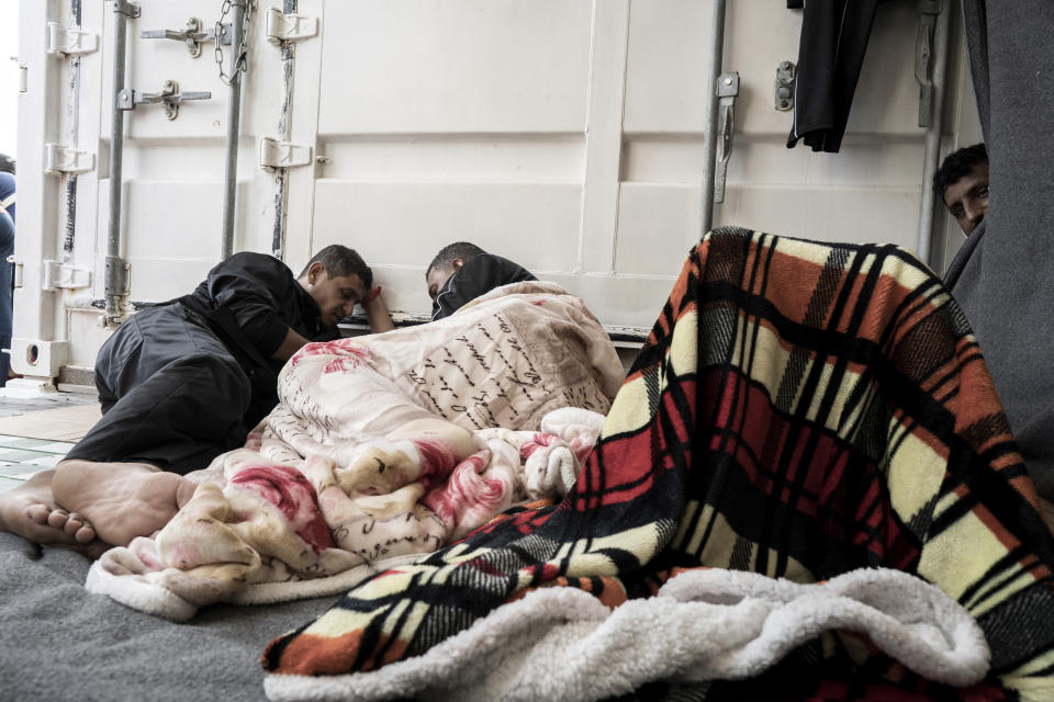 Some of the migrants rescued from the sea are seen on board of the humanitarian ship Ocean Viking cruising in the Mediterranean Sea, Wednesday, Nov. 9, 2022. The SOS Mediterranee humanitarian group said the Norwegian-flagged ship is heading toward the French island of Corsica in hopes that France will offer its 234 passengers a safe port, after Italy backed down and allowed migrants from three other rescue ships to disembark on Italian soil. (AP Photo/Vincenzo Circosta)