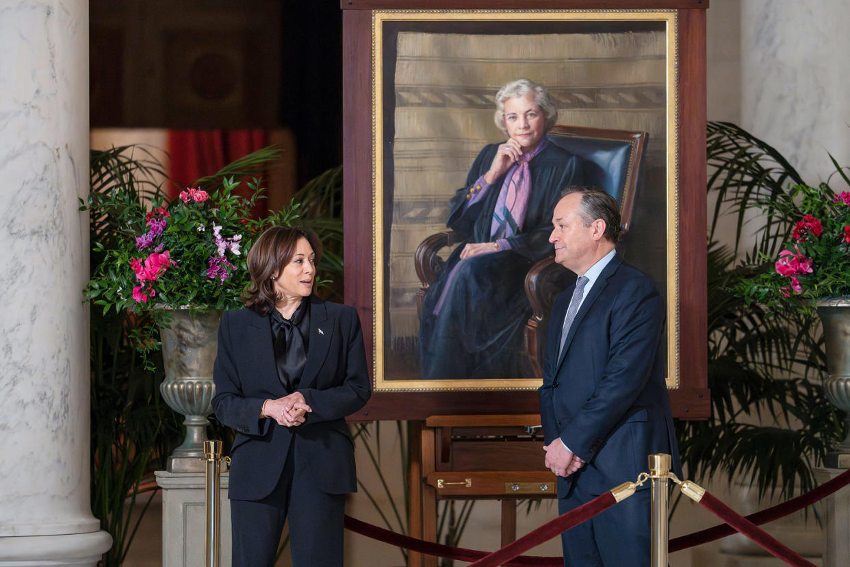 Kamala Harris and Doug Emhoff  walk past a portrait of Sandra Day O'Connor. (J. Scott Applewhite / AP)