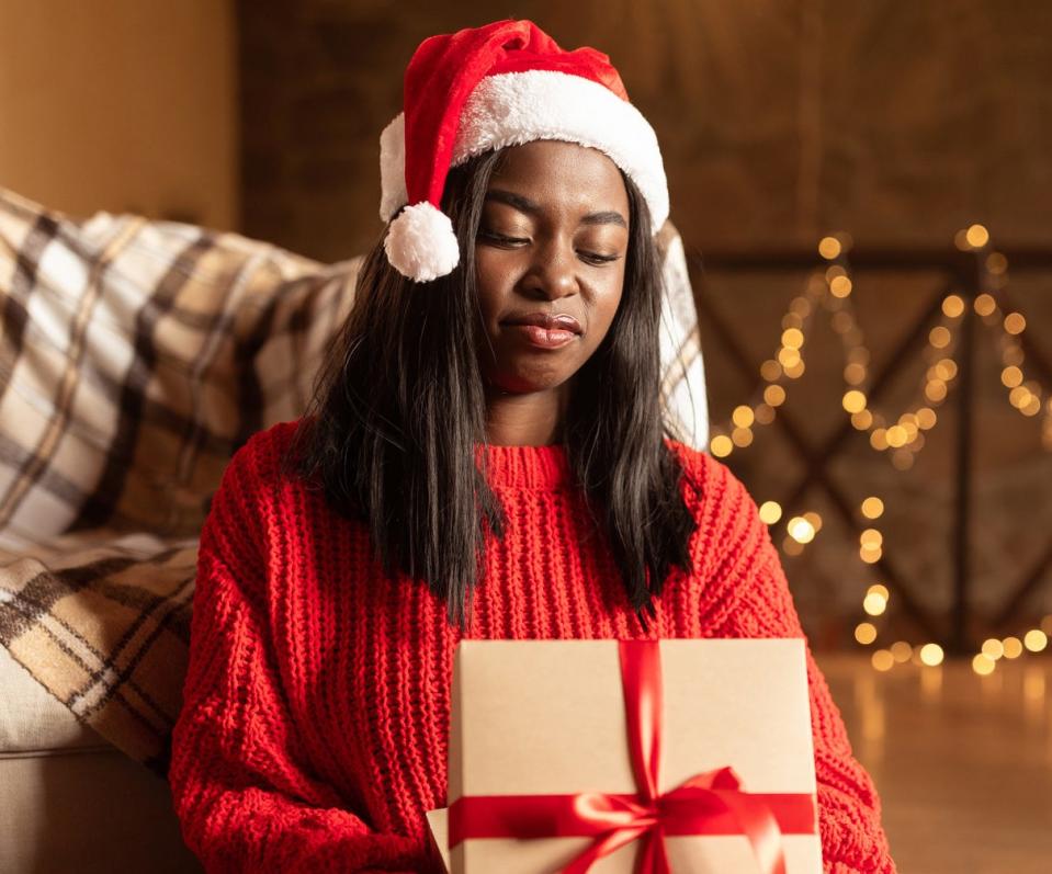 woman looking disappointedly at her present