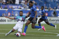 Minnesota United defender D.J. Taylor, left, slide-tackles CF Montreal forward Mason Toye (13) who shoots on goal during first-half MLS soccer match action in Montreal, Saturday, June 10, 2023. (Evan Buhler/The Canadian Press via AP)