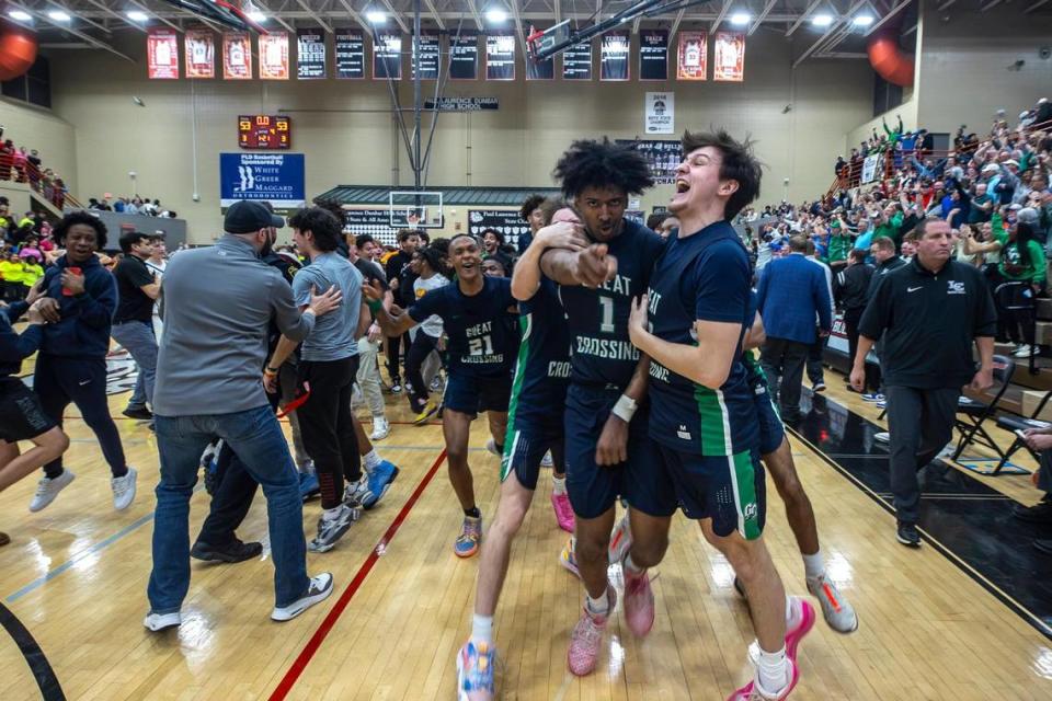 Great Crossing’s Vince Dawson (1) is surrounded by teammates after scoring a basket at the buzzer to beat Lexington Catholic during the boys 11th Region Tournament championship game at Paul Laurence Dunbar High School on Tuesday.