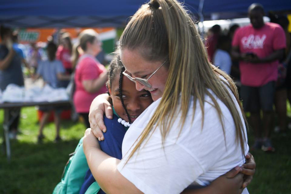 A hug is given at Knoxville Area Urban League’s Shoes for School event in Caswell Park, Saturday, Aug. 6, 2022.