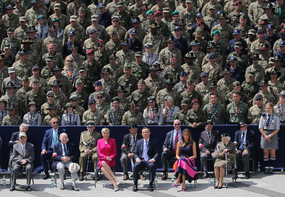 U.S. first lady Melania Trump, Polish President Andrzej Duda and Polish first lady Agata Kornhauser-Duda (center, right to left) listen to Trump's speech.