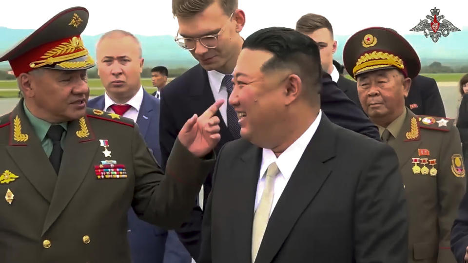 In this photo taken from video released by Russian Defense Ministry Press Service, North Korea's leader Kim Jong Un, right, smiles to Russian Defense Minister Sergei Shoigu, left, as he inspects Russian warplanes at the Vladivostok International airport in Vladivostok, Russian Far East on Saturday, Sept. 16, 2023. (Russian Defense Ministry Press Service via AP)
