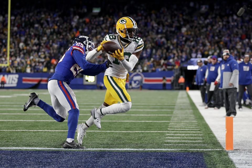 Green Bay Packers wide receiver Malik Heath (18) catches a pass against New York Giants cornerback Deonte Banks (25) for a touchdown during the fourth quarter of an NFL football game, Monday, Dec. 11, 2023, in East Rutherford, N.J. (AP Photo/Adam Hunger)