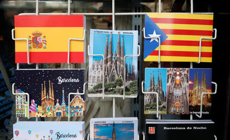 Postcards showing Spanish flag, an Estelada (Catalan separatist flag) and Sagrada Familia are displayed at a souvenirs shop in Barcelona, Spain, December 12, 2018. REUTERS/Albert Gea