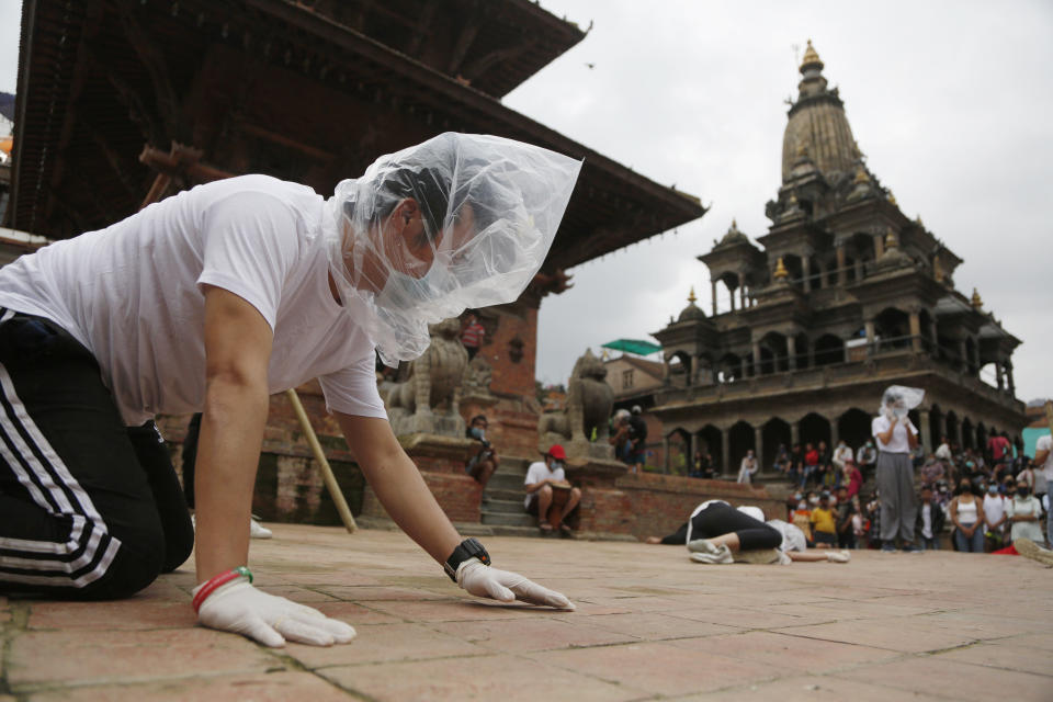 FILE - In this June 30, 2020, file photo, Nepalese youth perform a play as part of a protest demanding better COVID-19 management at Patan Durbar Square near Kathmandu, Nepal. (AP Photo/Niranjan Shrestha, File)