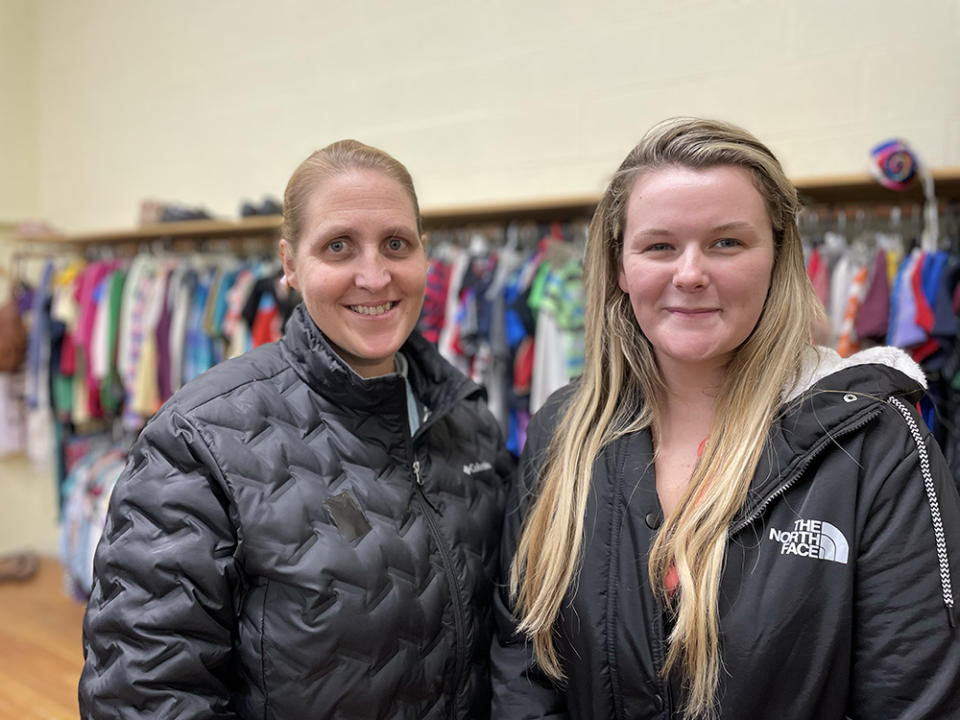 Rebecca Lewis, left, and Brittnee Dwyer, right, of Northeast Kingdom Community Action stand in their organization’s no-cost store where struggling families can access food and clothing. (Asher Lehrer-Small)