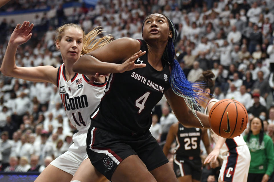 South Carolina&#39;s Aliyah Boston (4) drives to the basket as UConn&#39;s Dorka Juhasz (14) defends in the second half of an NCAA college basketball game, Sunday, Feb. 5, 2023, in Hartford, Conn. (AP Photo/Jessica Hill)
