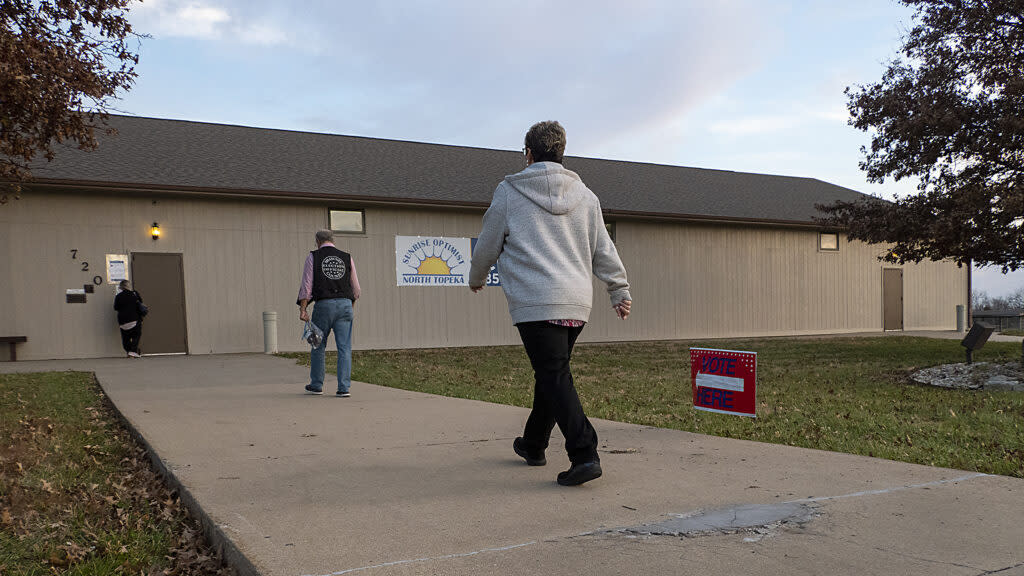 Voters walking toward door of polling place