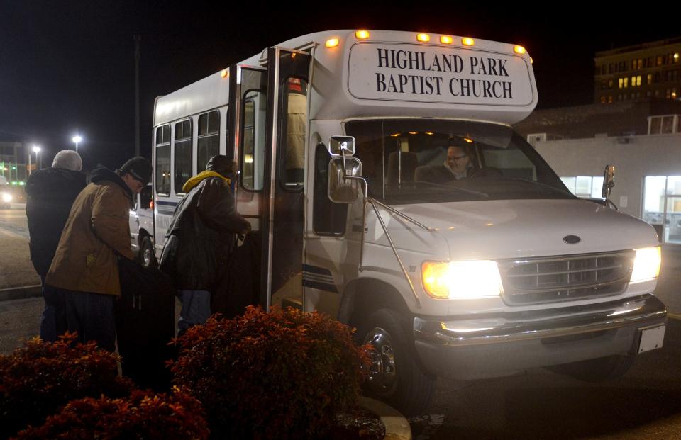 In this 2015 file photo, participants in the Room in the Inn program, which provides overnight shelter for homeless men at local churches, board the Highland Park Baptist Church bus outside of Area Relief Ministries.