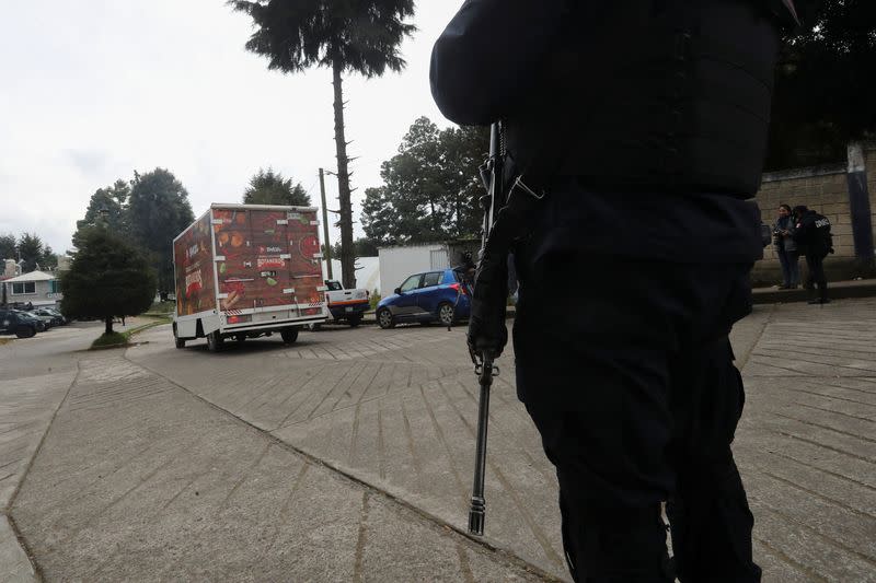 A police officer operates in an area following villagers' bloody takedown of extortionists in Texcapilla