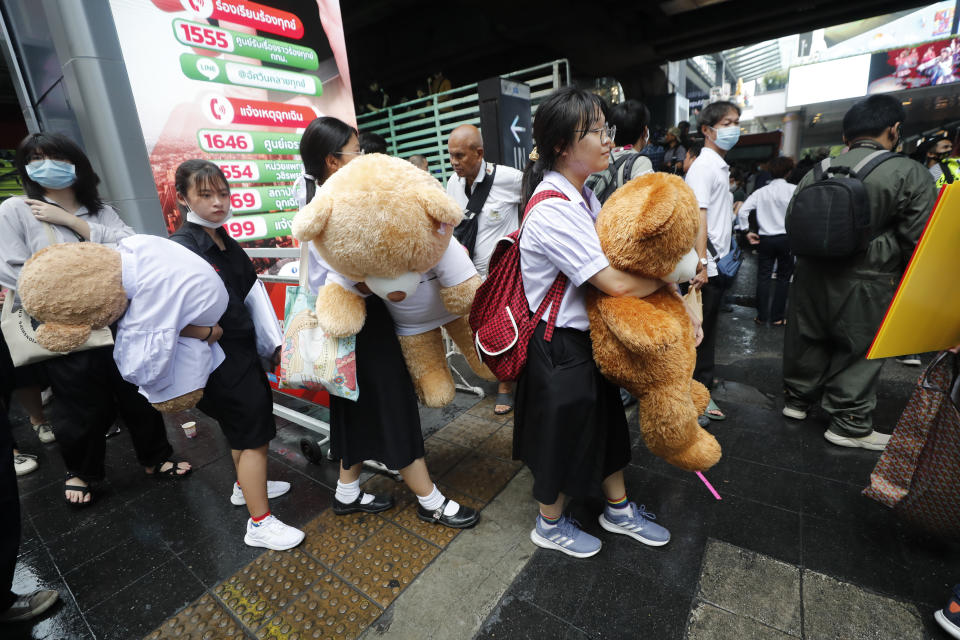 Secondary school students hold giant teddy bears as they attend a student rally in Bangkok, Saturday, Nov. 21, 2020. Organized by a group that mockingly calls themselves "Bad Students," the rally calls for educational reforms and also supports the broader pro-democracy movement's demands for constitutional change. (AP Photo/Sakchai Lalit)