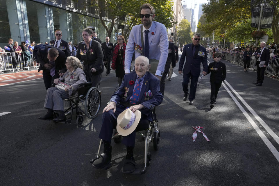 Veterans are pushed in wheelchairs during the Anzac Day parade in Sydney, Tuesday, April 25, 2023. (AP Photo/Rick Rycroft)