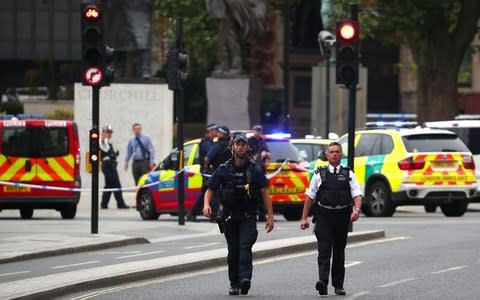 Armed police in Parliament Square - Credit: HANNAH MCKAY /Reuters