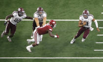 Texas A&M quarterback Kellen Mond (11) carries the ball as offensive lineman Carson Green (54) and running back Jacob Kibodi (23) block Arkansas linebacker De'Jon Harris (8) during the second half of an NCAA college football game Saturday, Sept. 28, 2019, in Arlington, Texas. Texas A&M won 31-27. (AP Photo/Ron Jenkins)