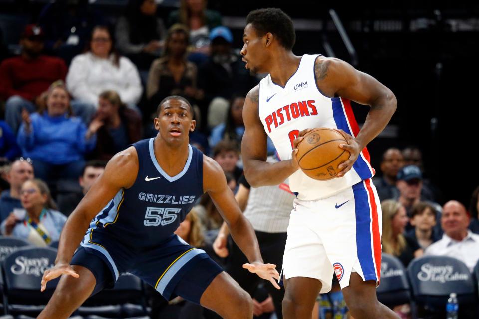 Pistons center Jalen Duren handles the ball as Grizzlies center Trey Jemison defends during the first half on Friday, April 5, 2024, in Memphis, Tennessee.