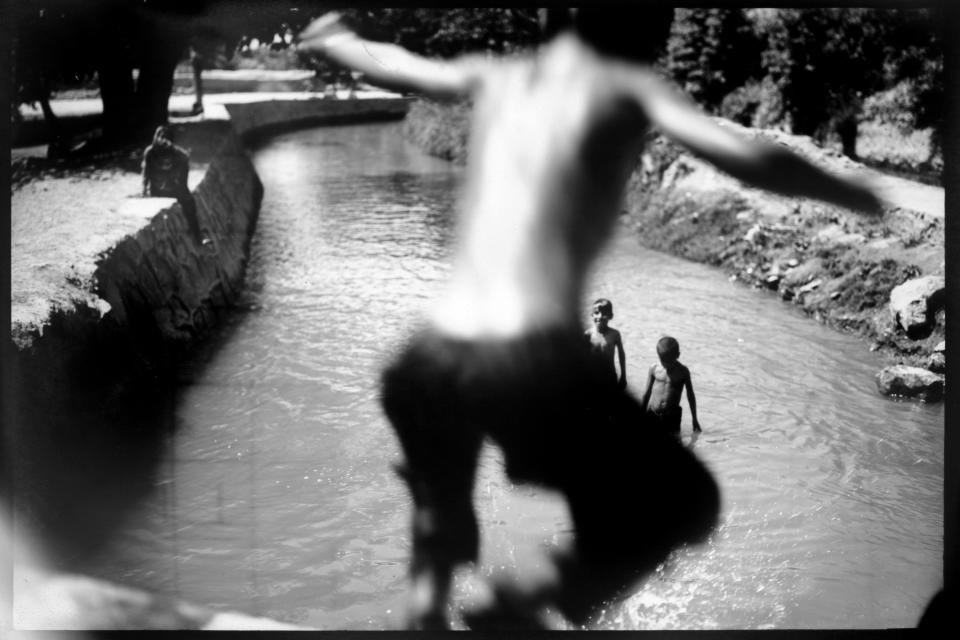 Children cool off in an irrigation canal in the Arghandab River valley in Kandahar province, Afghanistan, Monday, June 12, 2023. (AP Photo/Rodrigo Abd)