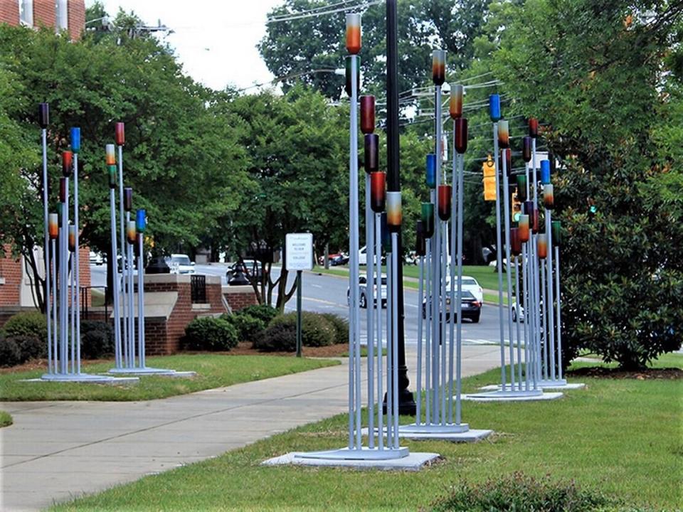 UNC Charlotte art professor Keith Bryant’s “Procession” (above) was installed last June CPCC’s main campus. It’s located in front of the Overcash building along Kings Drive. The large-scale sculpture is crafted from materials found in a scrap yard, including old fire extinguishers which were used as colorful pole toppers.