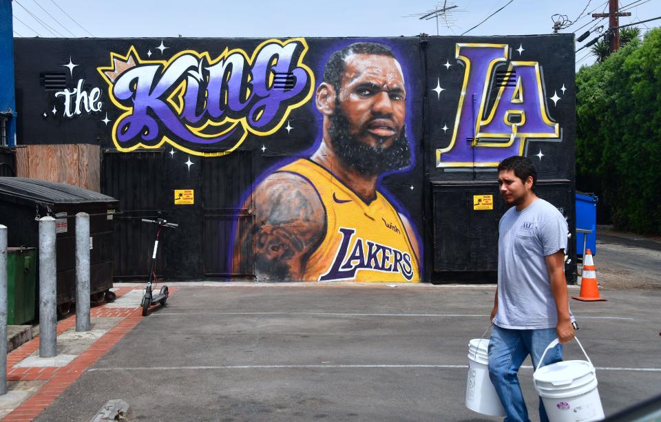 In Los Angeles, freshly painted LeBron James murals became a target for longtime Kobe Bryant supporters unhappy about the arrival of a player they have long vilified. (Getty Images)