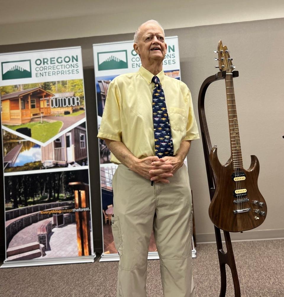 A custom Prison Blues guitar made from a fallen 150-year-old maple tree at the Oregon State Capitol is presented to retired Senate President Peter Courtney on Friday at the Oregon Corrections Enterprises showroom.