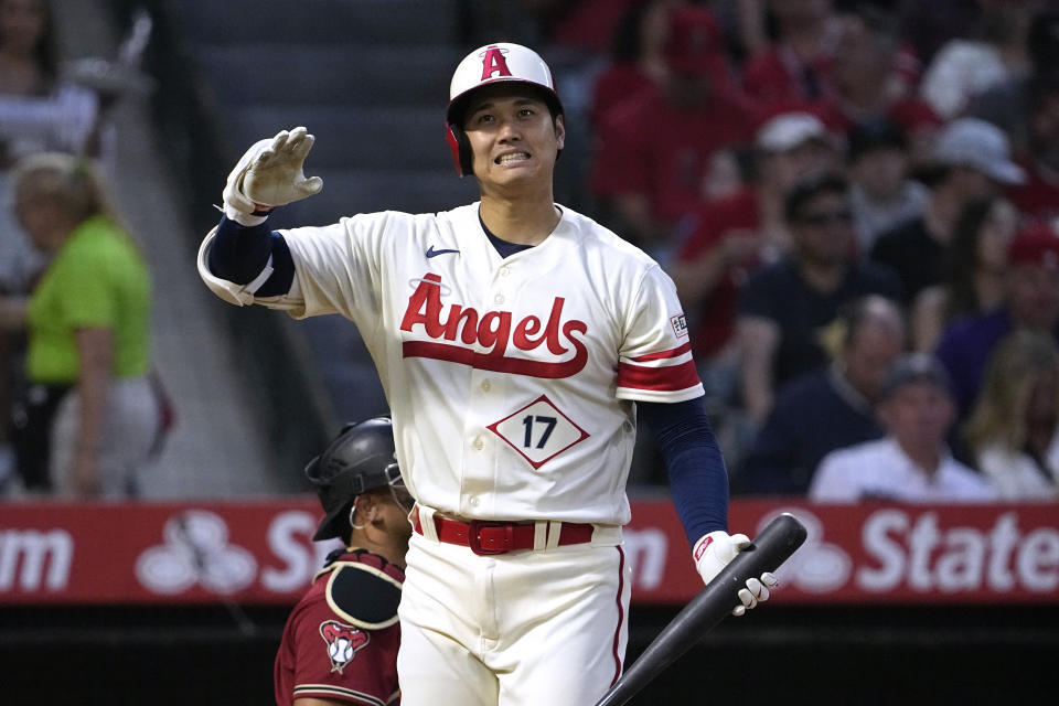 Los Angeles Angels' Shohei Ohtani grimaces after swinging for a strike during the fourth inning of a baseball game against the Arizona Diamondbacks Saturday, July 1, 2023, in Anaheim, Calif. (AP Photo/Mark J. Terrill)