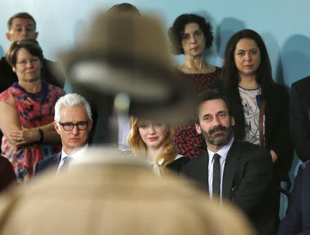 Seated beyond the top hat and suit of Mad Men lead character "Don Draper," stars (L-R) John Slattery, Christina Hendricks and Jon Hamm take part in a donation ceremony at the Smithsonian National Museum of American History in Washington March 27, 2015. REUTERS/Kevin Lamarque