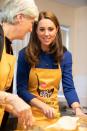 Kate Middleton happily donned an apron on Wednesday, helping to prepare lunch during a visit to the homelessness charity Centrepoint.
