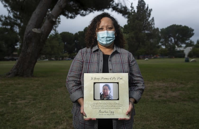 RESEDA, CA-JUNE 5, 2020: Griselda Nava, 48, photographed at a park, located across the street from Parkwest Healthcare Center in Reseda, holds a photograph of her mother, Florentina Lopez, who died on May 19 from COVID-19 at the age of 66. Lopez was a resident for the past 7 years at Parkwest. A wrongful death lawsuit has been filed against the healthcare center. (Mel Melcon/Los Angeles Times)