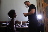 A model gets her make-up done in the backstage at the "We are Made in Italy - Black Lives Matter in Italian fashion Collection" event during the Milan's fashion week in Milan, Italy, Thursday, Sept. 17, 2020. (AP Photo/Antonio Calanni)