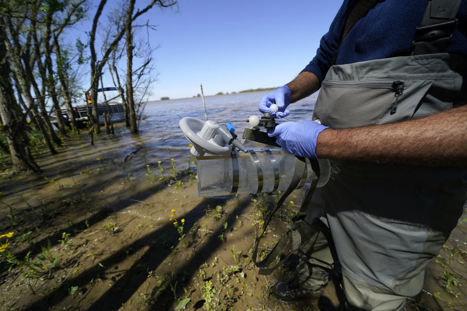 Mike Lamb, co-investigator, of the California Institute of Technology, prepares to take water samples to measure the amount of sediment in the water, in the Wax Lake area of the Atchafalaya River delta system, near Franklin, La., Friday, April 2, 2021. NASA is using high-tech airborne systems along with boats and mud-slogging work on islands for a $15 million study of these two parts of Louisiana's river delta system. (AP Photo/Gerald Herbert)