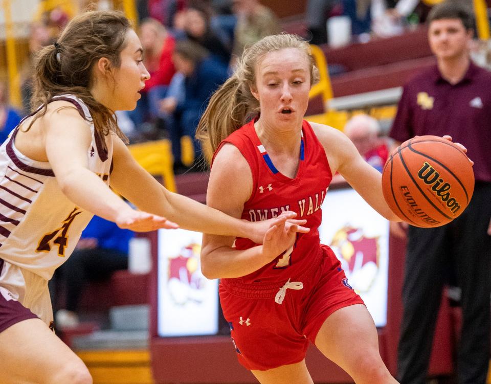 Owen Valley's Lily Smith (1) drives past North's Ava Robbennolt (24) during the Bloomington North versus Owen Valley girls basketball game at Bloomington North High School on Tuesday, Dec. 6, 2022.