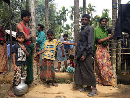 Rohingya Muslims gather outside their makeshift homes on land belonging to Bangladeshi farmer Jorina Katun near Kutapalong refugee camp in the Cox's Bazar district of Bangladesh February 9, 2018. Picture taken February 9, 2018. REUTERS/Andrew RC Marshall