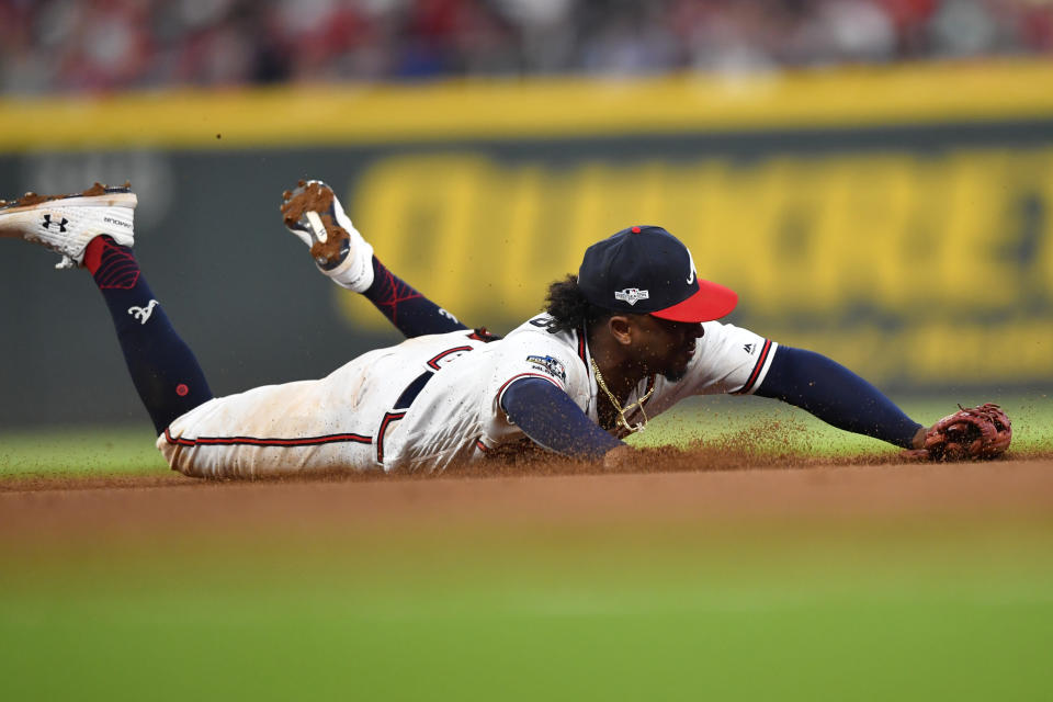 Atlanta Braves center fielder Ronald Acuna Jr. (13) can't get his glove on a ball hit by St. Louis Cardinals third baseman Tommy Edman in the ninth inning during Game 1 of a best-of-five National League Division Series, Thursday, Oct. 3, 2019, in Atlanta. (AP Photo/John Amis)