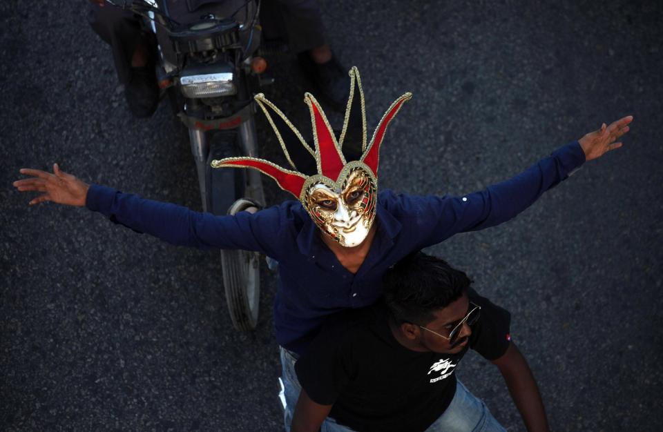 FILE - A Pakistani Christian wears mask while participating in a peace rally in connection with a Christmas celebration, in Karachi, Pakistan, Wednesday, Dec. 21, 2016. Although Pakistani Christians are in the minority, Christmas is a national holiday and is observed across the country as an occasion to celebrate (AP Photo/Shakil Adil, File)