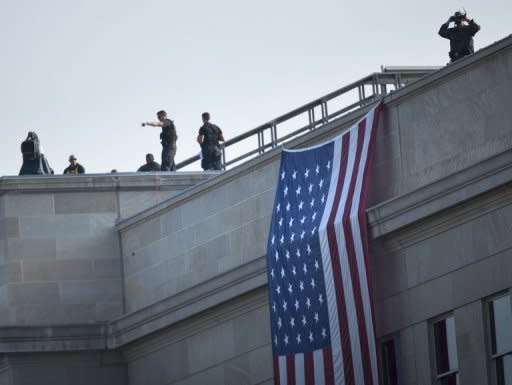 Members of the Secret Service counter sniper team and other security take positions on the roof before a memorial service at the Pentagon, in 2011, in Arlington, Virginia. The Secret Service, which employs some 3,200 agents and 1,300 uniformed police, has been in the spotlight for a number of notable incidents since Obama took office three years ago