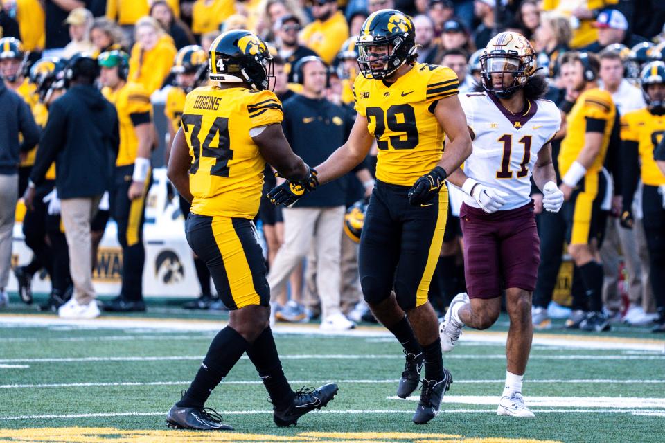 Iowa defensive back Sebastian Castro (29) and linebacker Jay Higgins (34) high five after a play at Kinnick Stadium on Saturday, October 21, 2023 in Iowa City.