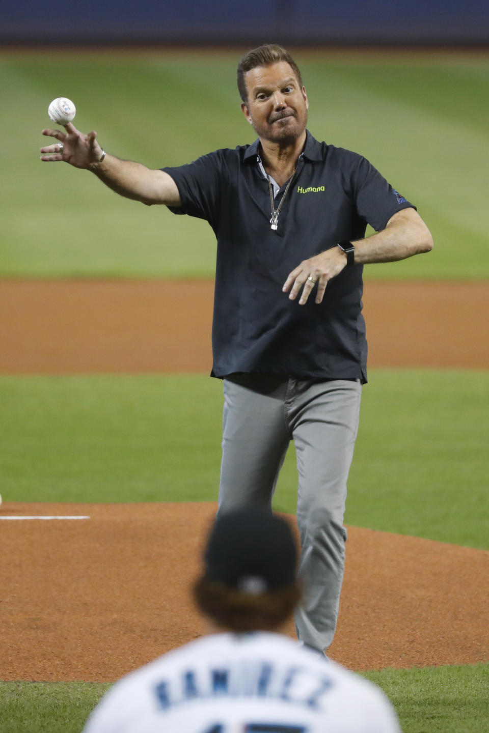 Cuban-American Grammy award winner Willy Chirino throws out a ceremonial first pitch to Miami Marlins' Harold Ramirez before the start of a baseball game between the Marlins and the Milwaukee Brewers, Thursday, Sept. 12, 2019, in Miami. (AP Photo/Wilfredo Lee)