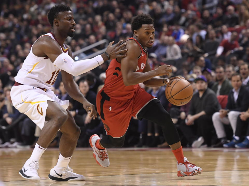 Toronto Raptors guard Kyle Lowry (7) moves pass Cleveland Cavaliers guard David Nwaba (12) to score in the final seconds of the first half NBA basketball action in Toronto on Wednesday, Oct. 17, 2018. (Nathan Denette/The Canadian Press via AP)