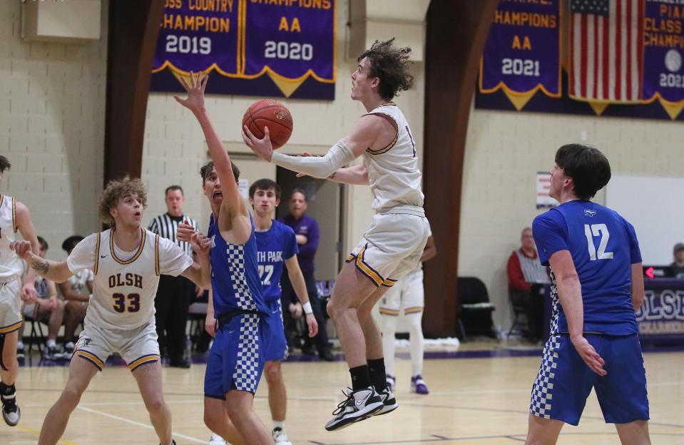 OLSH's Rocco Spadafora (1) goes for layup over the head of South Park's Luke Scarff (11) during the second half Friday night at Our Lady of the Sacred Heart High School.