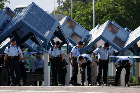 Policemen search the area after a woman opened fire and wounded four people at a park outside Taikoo Shing in Hong Kong, China June 26, 2018. REUTERS/Bobby Yip TPX IMAGES OF THE DAY