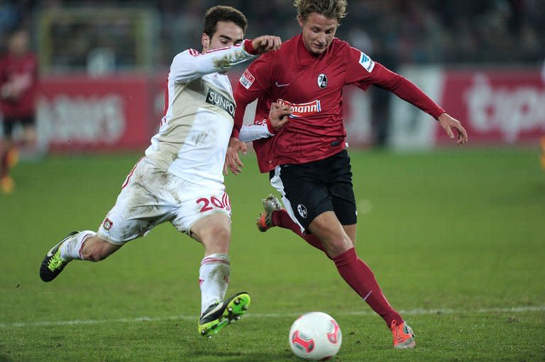 Leverkusen's defender Daniel Carvajal (R) clashes with Freiburg's defender Vegar Hedenstad during their German first division Bundesliga football match in Freiburg, southern Germany, on January 26, 2013. Bayer Leverkusen reclaimed second place in the Bundesliga from defending champions Borussia Dortmund on Saturday, despite being held to a goalless draw at gritty Freiburg