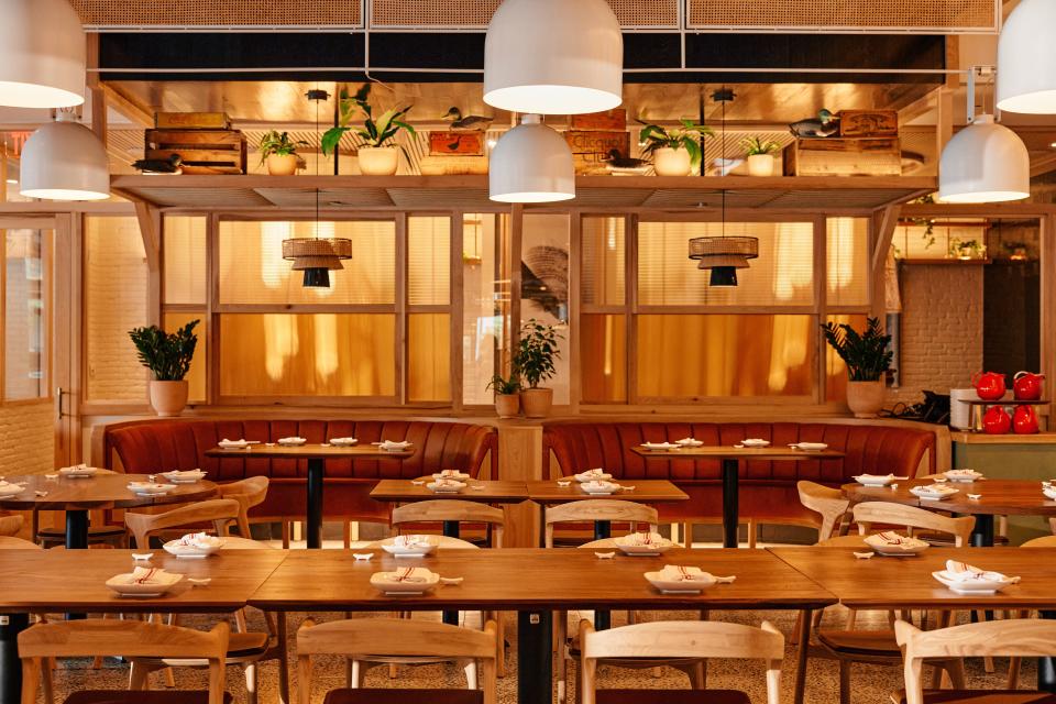 White painted brick, plants and warm wood tones make Red Farm look more like a modernist farm-to-table restaurant than a stereotypical Chinese restaurant.