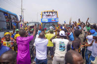 Bola Ahmed Tinubu, foreground right, presidential candidate of the All Progressives Congress, Nigeria ruling party, rides on a double decker bus during an election campaign rally in Lagos Nigeria, Tuesday, Feb 21, 2023. (AP Photo/ Efunla Ayodele)