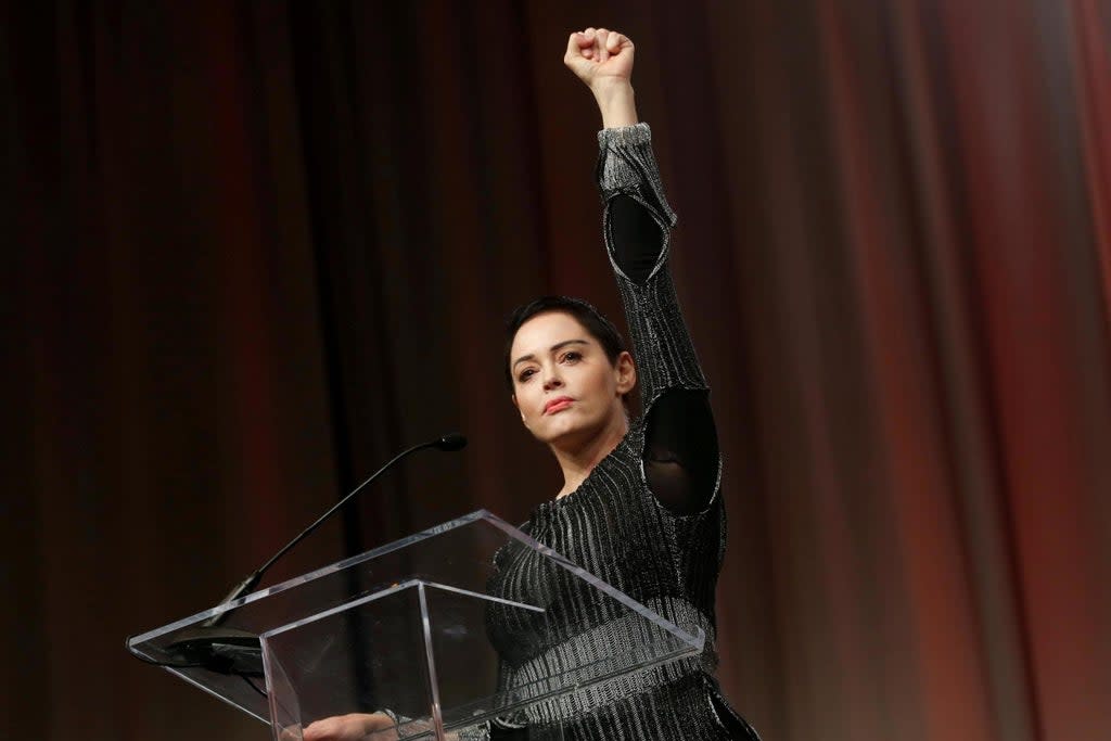 Actor Rose McGowan raises her fist after addressing the audience during the opening session of the three-day Women's Convention in Detroit, October 2017. (Reuters)