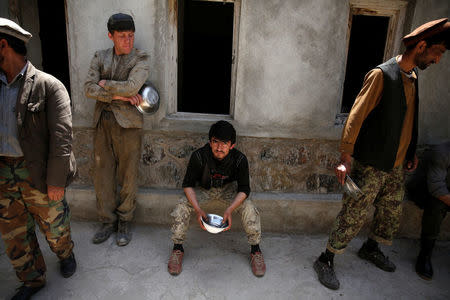 Workers wait for lunch at the Jabal Saraj cement factory in Jabal Saraj, north of Kabul, Afghanistan May 8, 2016. REUTERS/Ahmad Masood