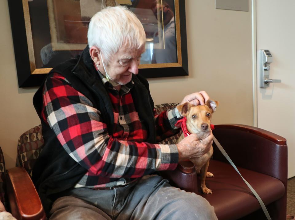 Ernie Banks the dog comforts Laszlo Nagy at the Desert Care Network's Comprehensive Cancer Center at Desert Regional Medical Center in Palm Springs on Nov. 17. Ernie volunteers once a week with his human guardian, Winston Gieseke.